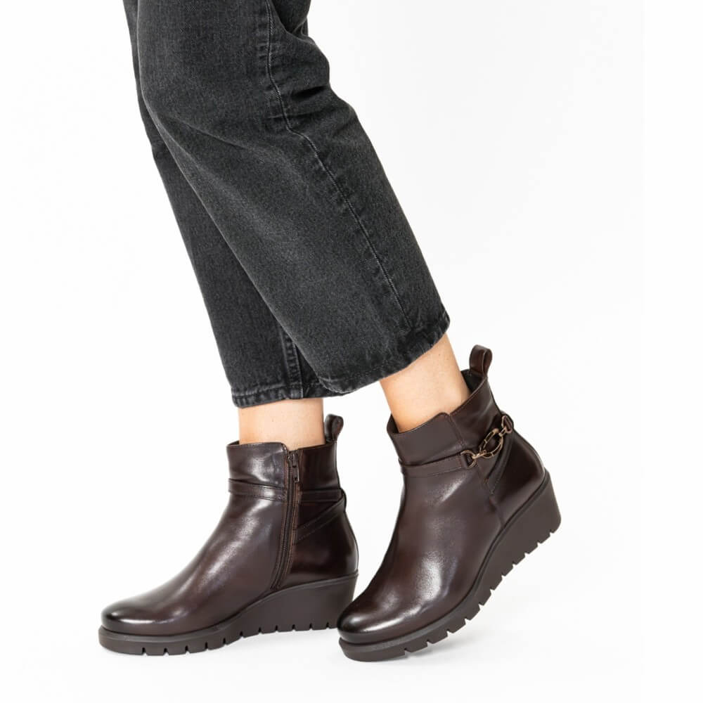 Brown ankle boots worn with black jeans on a white background Ara Como Wedge Ankle Boots H-Fit 12-57002 Cacao Brown