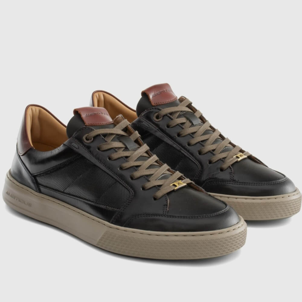 Pair of brown and Kaki sneakers with brown laces and soles on a light grey background