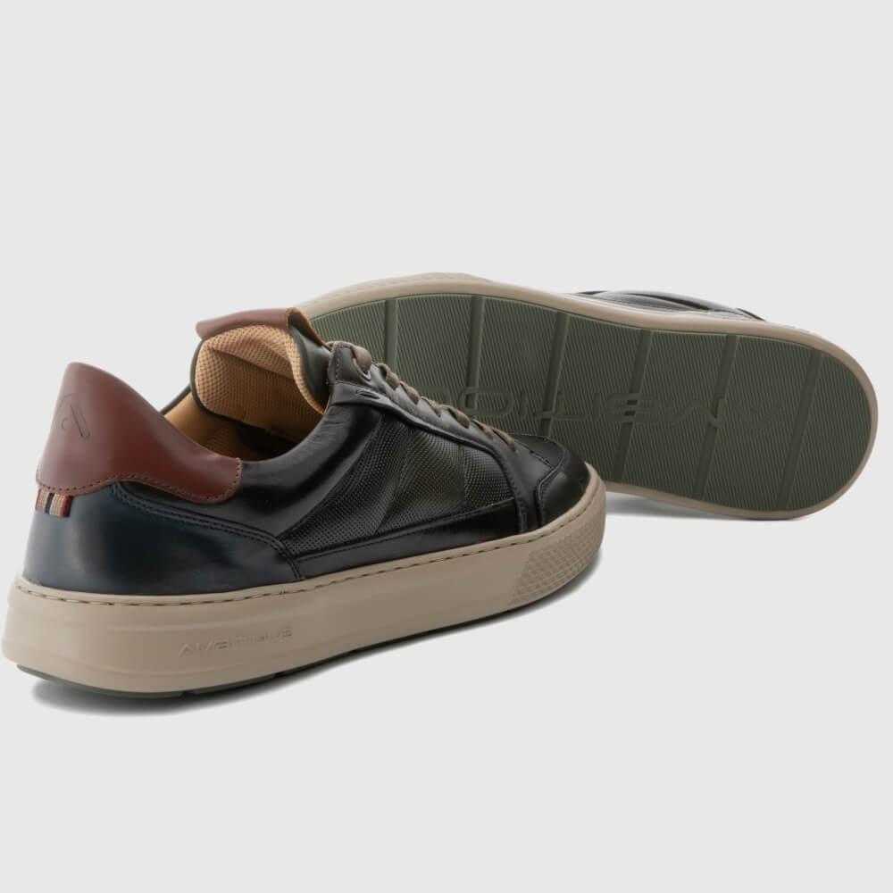 Pair of brown and Kaki sneakers with brown laces and soles on a light grey background