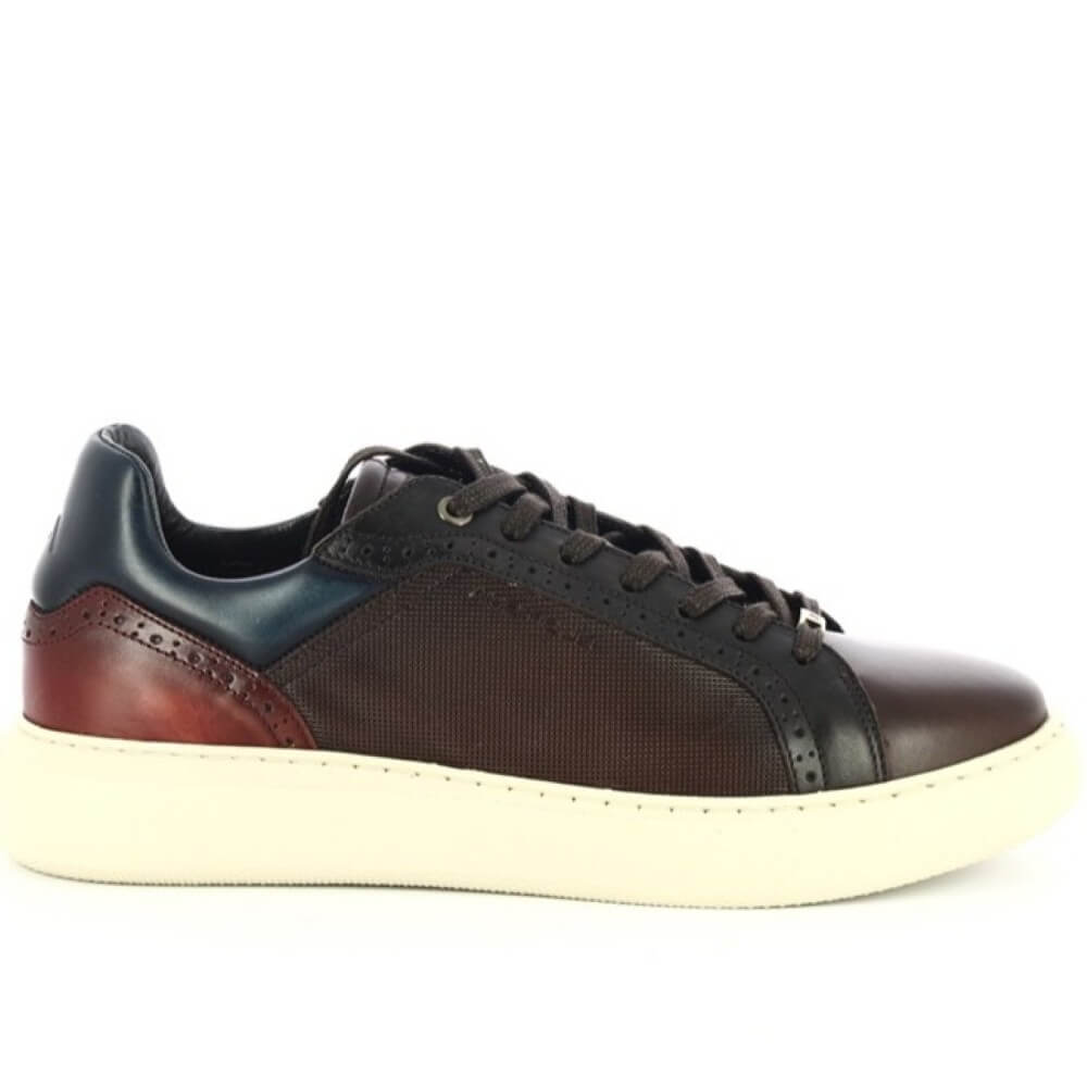 Multicolored sneaker with brown, black, and red accents on a white background