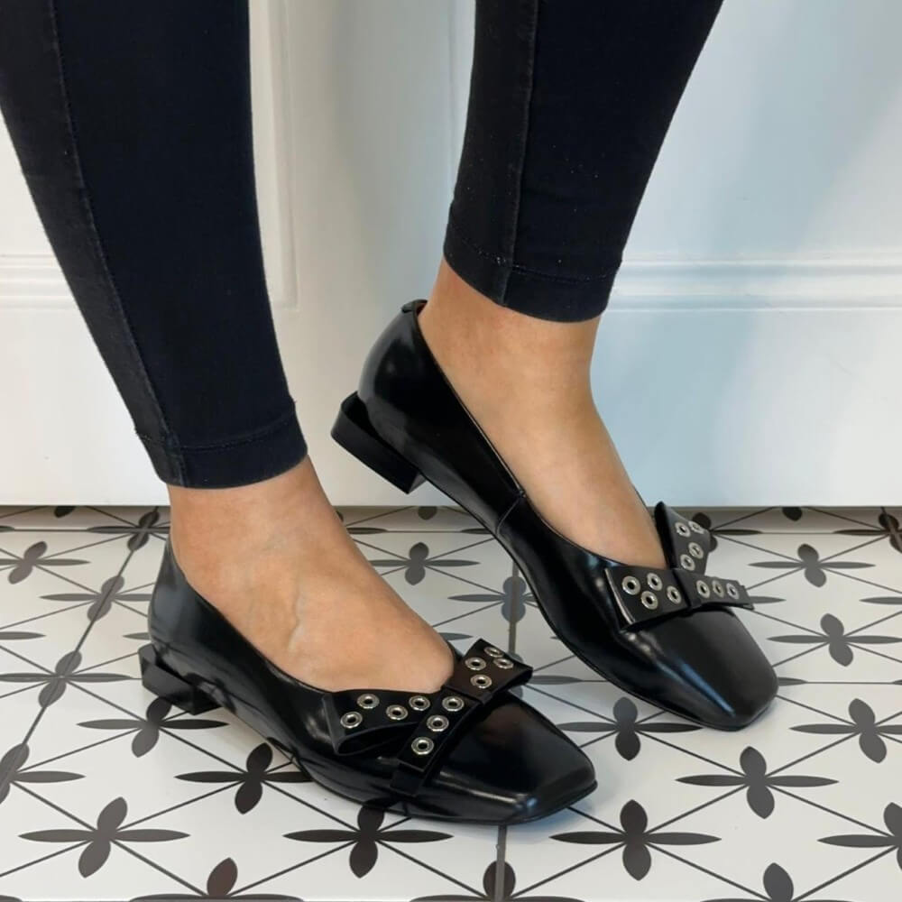 Black pointed-toe flats with silver embellishments and a black bow Ángel Alarcón Adelia 25504 Flat Leather Shoe-BLACK