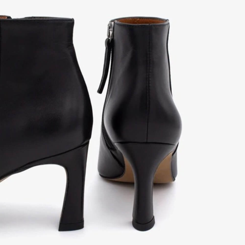 Black ankle boot with silver eyelets on a white background Ángel Alarcón Clarine 25558 Leather Ankle Boot-BLACK