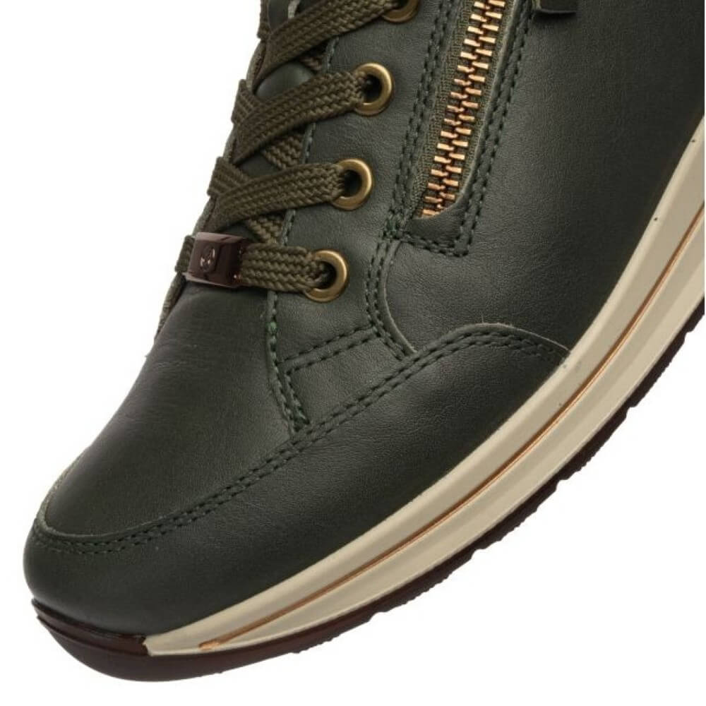 Close-up of a dark olive green leather lace-up shoe with a side zipper, gold-tone metal eyelets, and a cream-colored midsole on a white background.