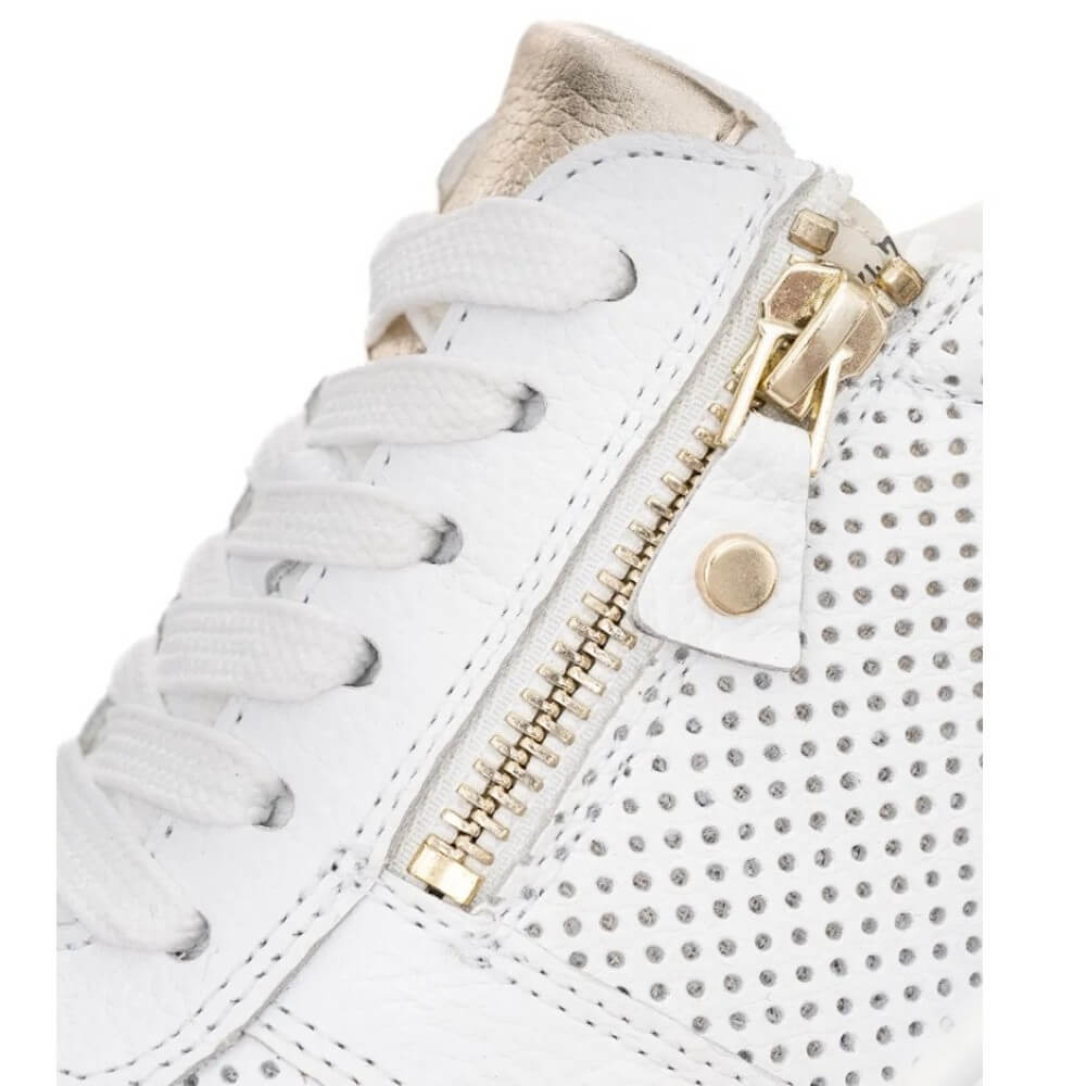 White sneaker with gold zipper and gold details on a white background