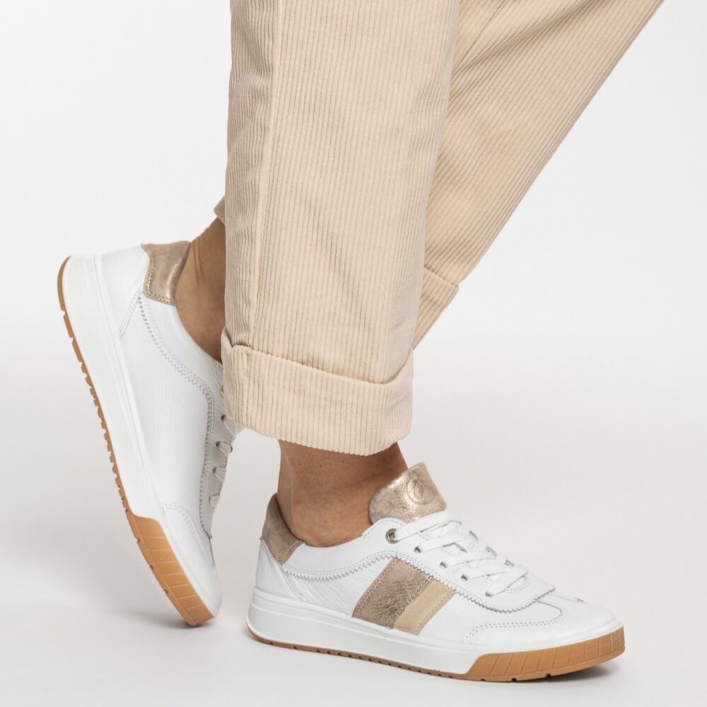 ara rom 12-50028 White sneakers with brown soles worn with beige pants on a white background