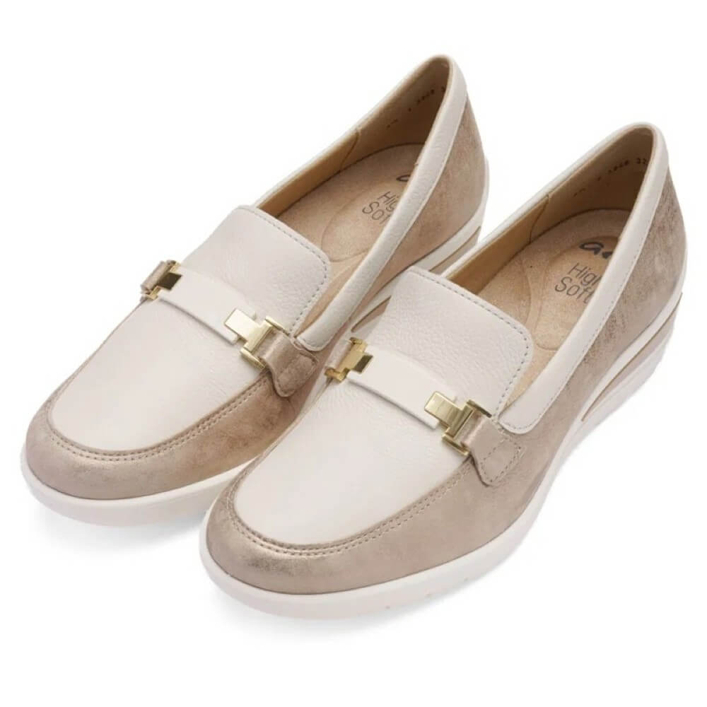 Pair of beige loafers with gold accents on a white background