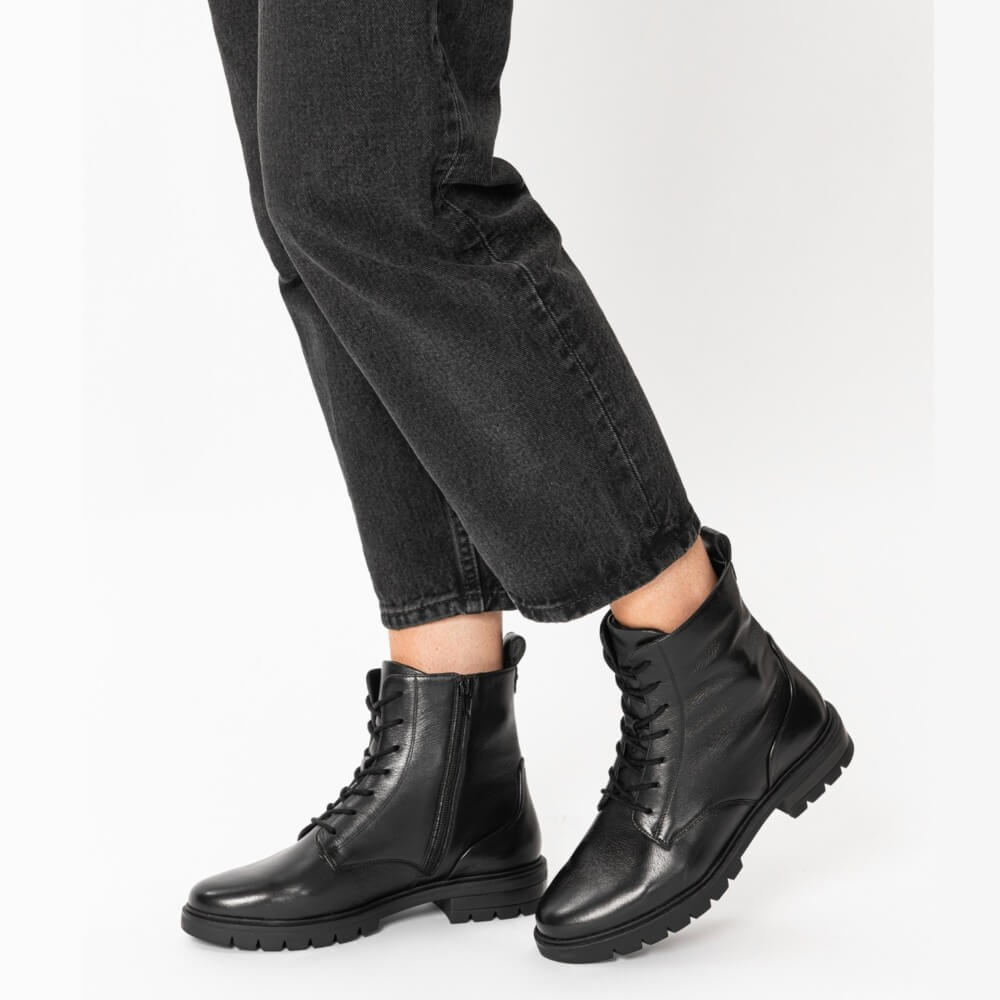 Black leather boots worn with black jeans on a white background Ara Cambridge Leather Laced Ankle Boots 12-11260 Black