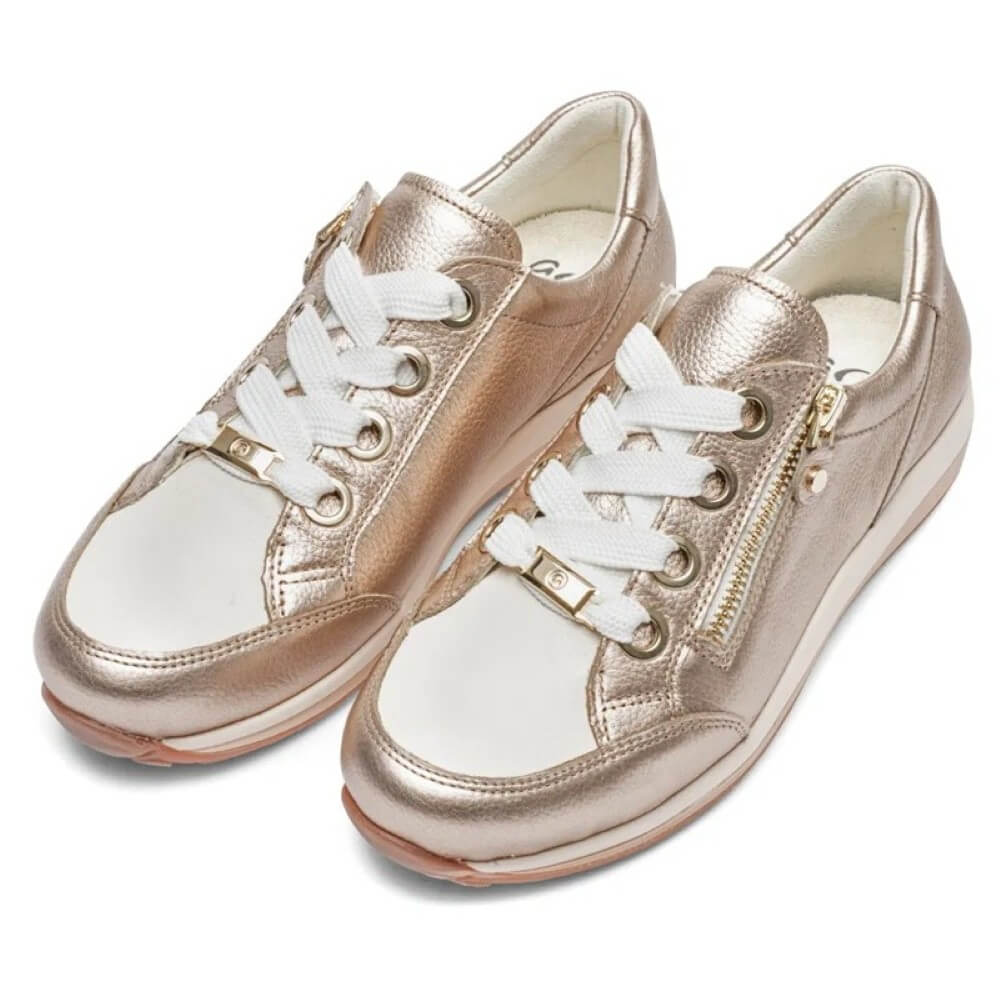 Pair of rose gold sneakers with white laces on a white background