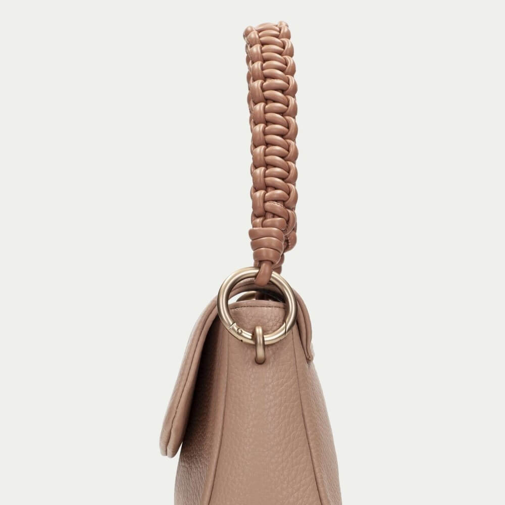 Hispanitas Beige handbag with braided handle on a light grey background