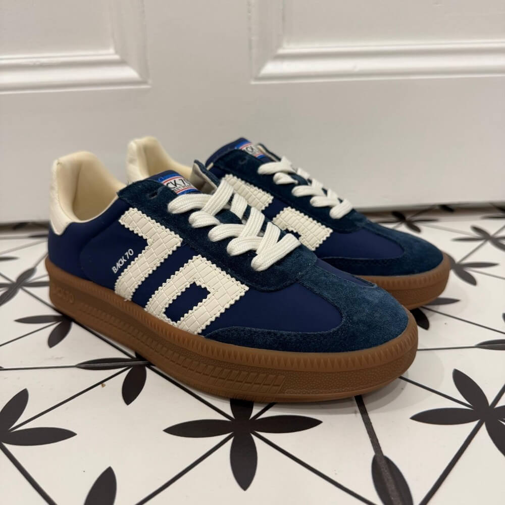 Back 70 Navy Blue and white sneakers with brown Gum soles on a patterned floor.
