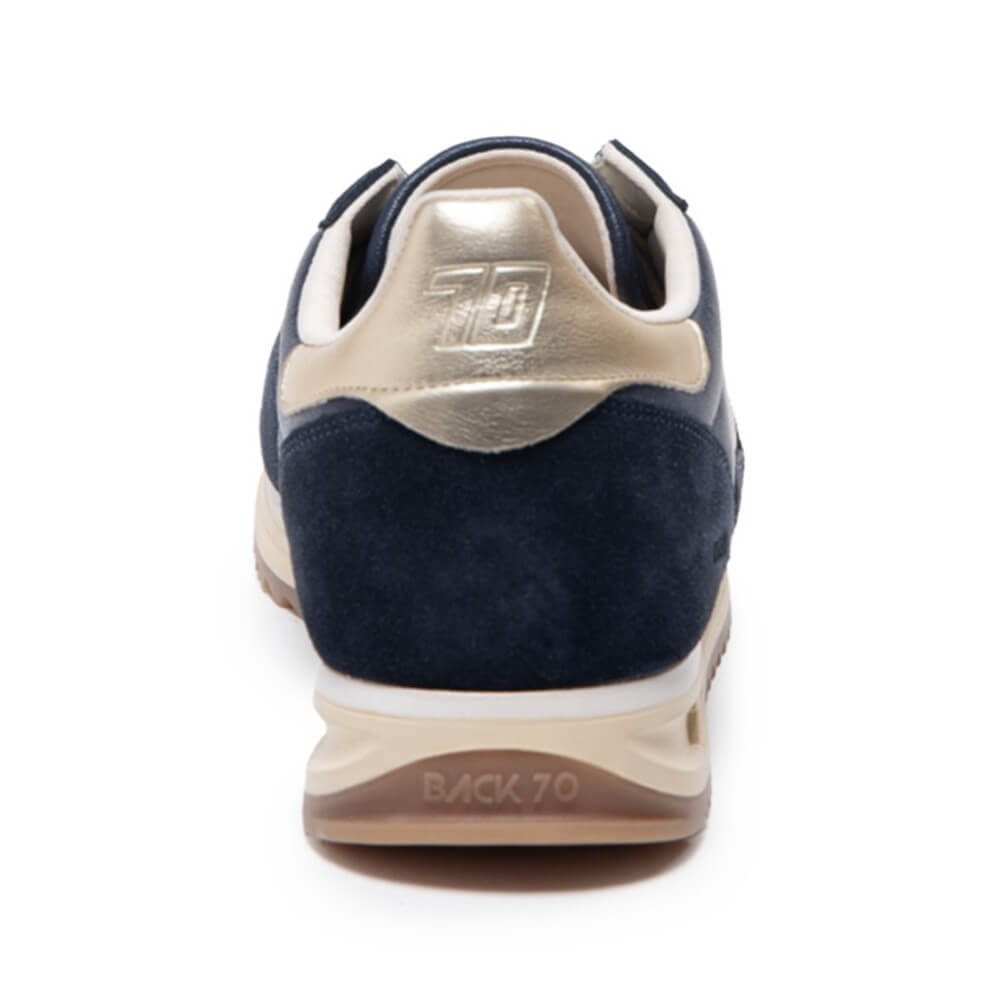 Navy blue sneaker with gold accents on a white background Back 70 Jogger N03 Navy Leather features a soft padded leather