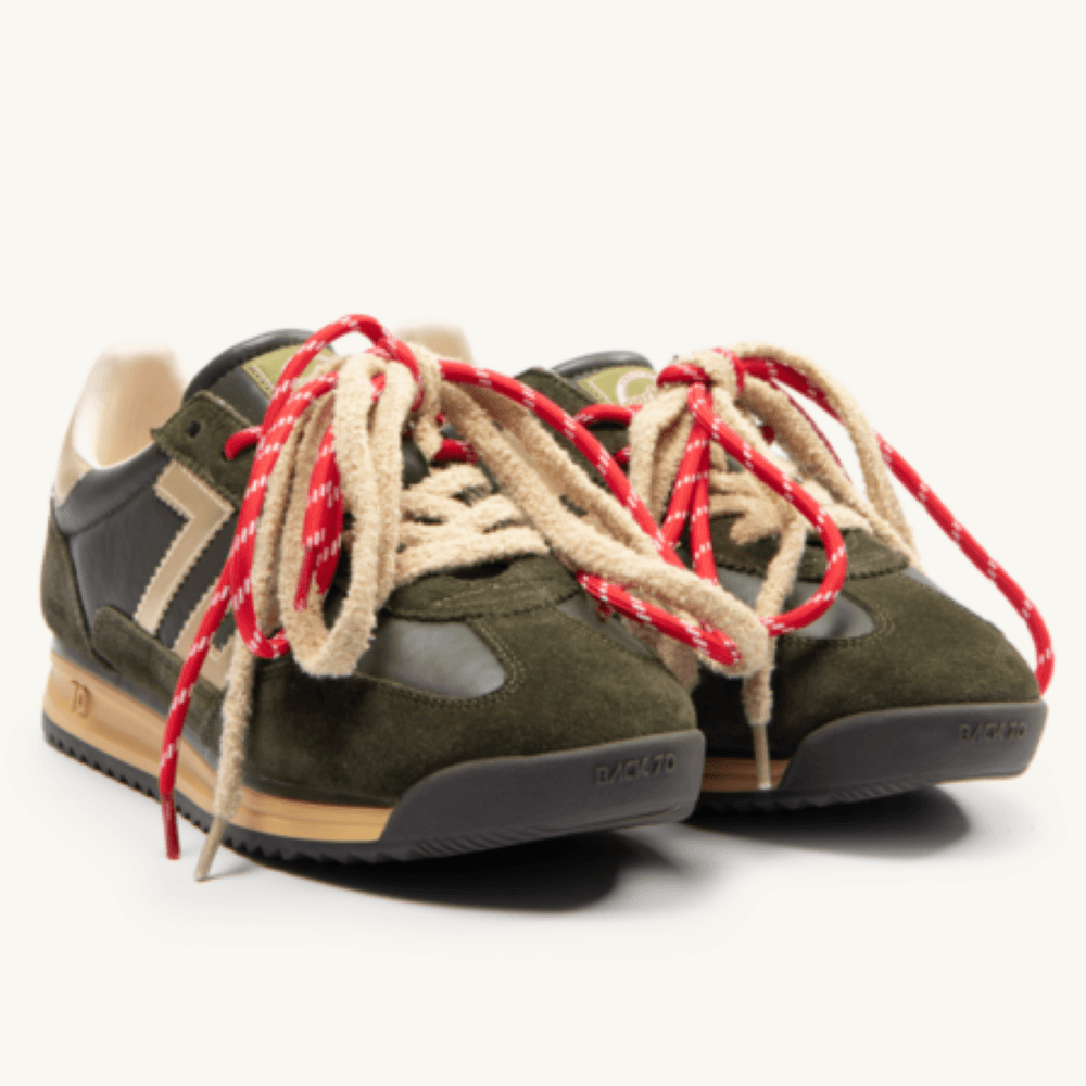 A pair of Back 70 vintage-style low-top sneakers in olive green suede and black leather, featuring chunky beige rope laces with red and white braided accents, tan midsoles, and black soles.