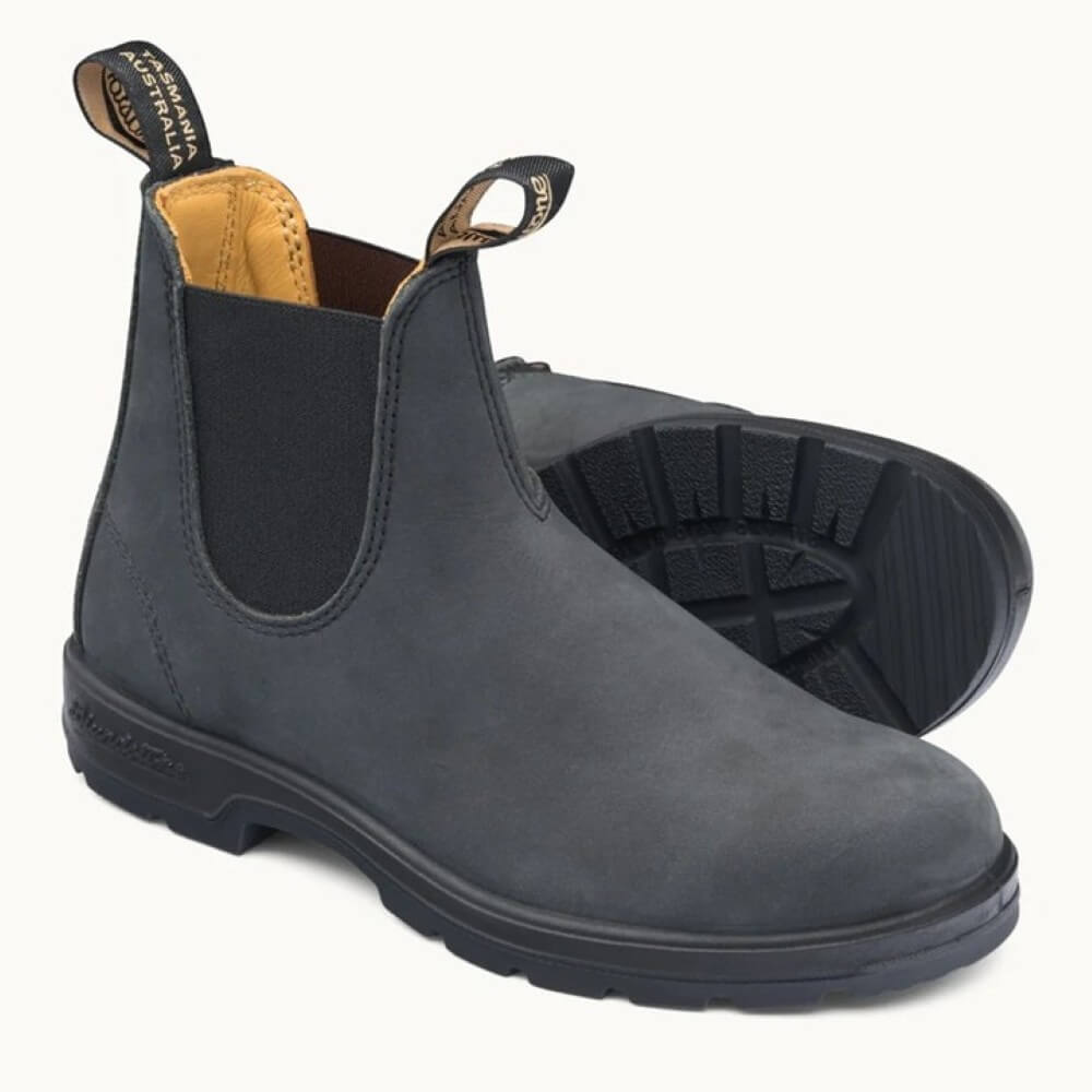 Pair of black leather Chelsea boots with black soles on a white background