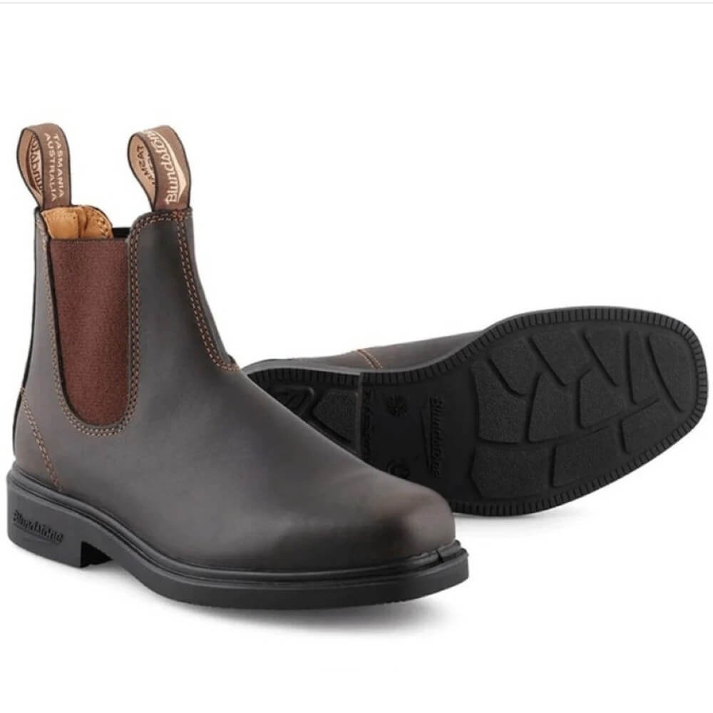 Pair of brown leather boots with black soles on a white background