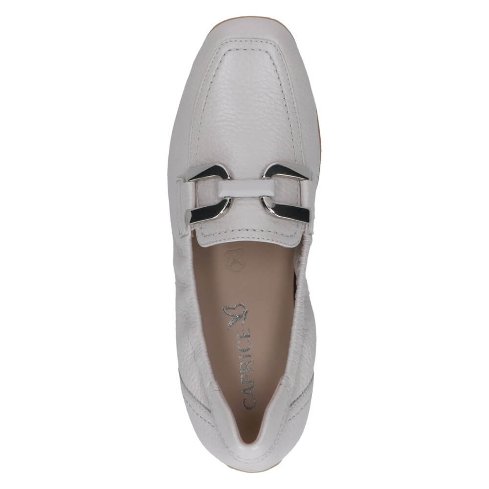 Off White loafer shoe with a decorative buckle on a white background