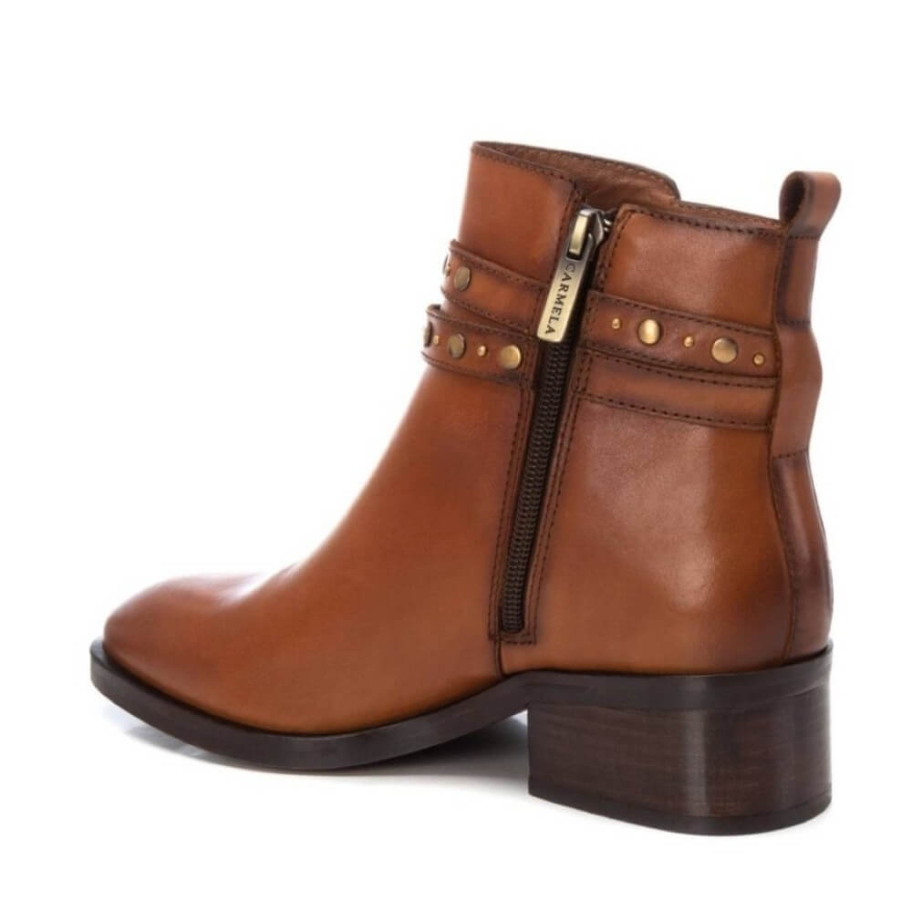 Brown leather boot with gold zipper and studs on a white background
