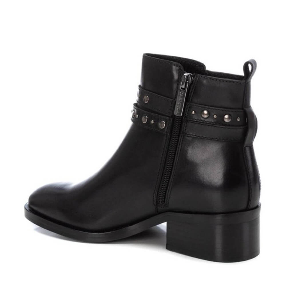 Black leather boot with studded details on a white background