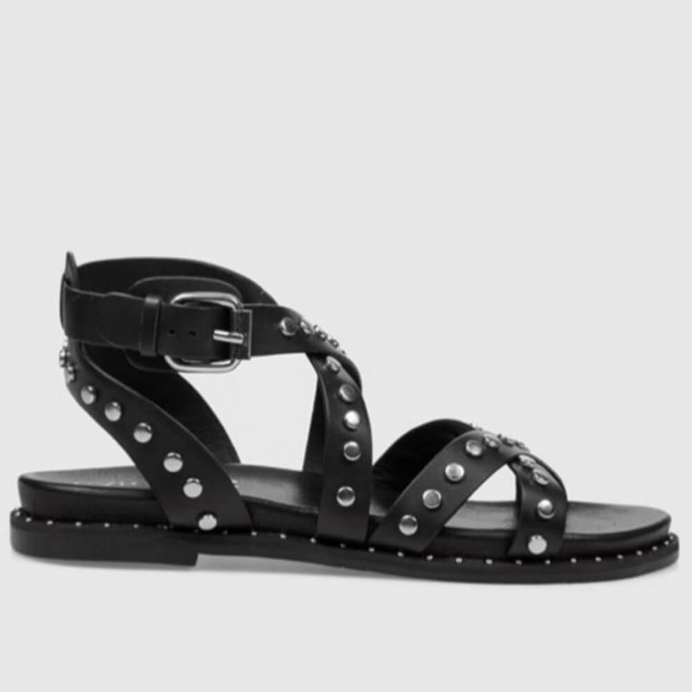 Carmela gladiator Black studded sandal on a light gray background