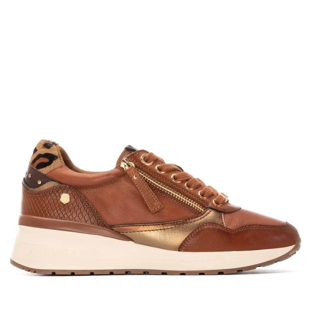 A Carmela brown leather sneaker with gold metallic panels, a leopard-print heel tab, and a thick cream-colored platform sole, shown in a side profile on a white background.
