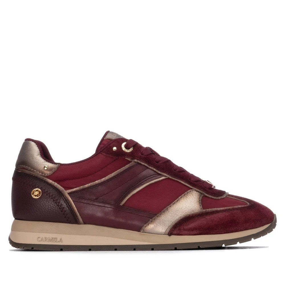 A Carmela low-top sneaker in burgundy and metallic gold leather with a beige midsole, shown in a side profile on a white background. The brand name 'CARMELA' is visible on the side of the sole.