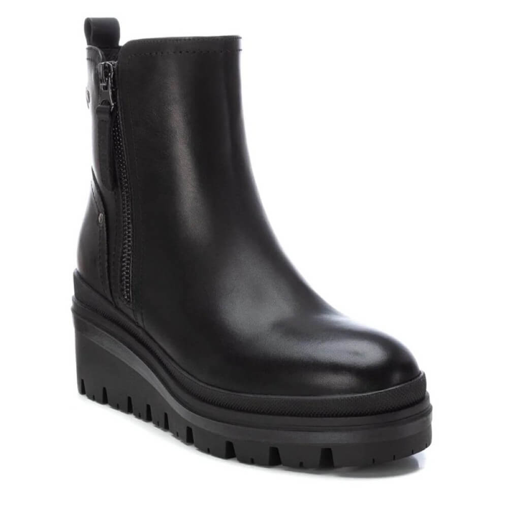 Black boot with a platform sole on a white background