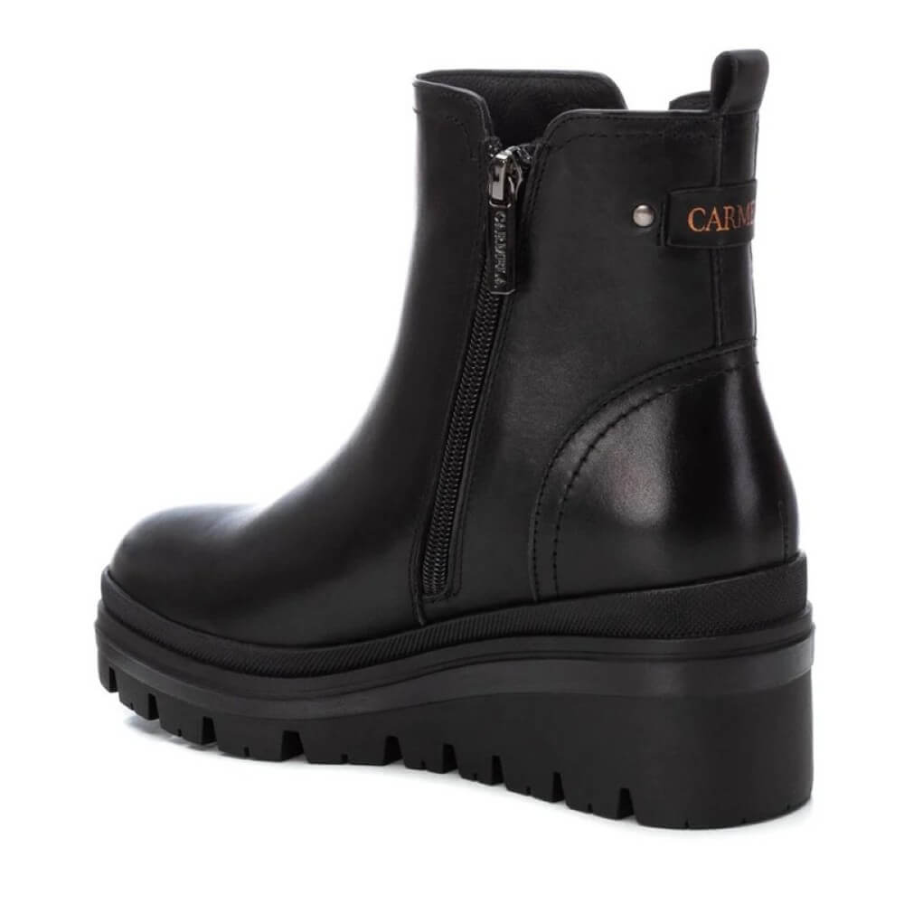 Black leather boot with a platform sole on a white background