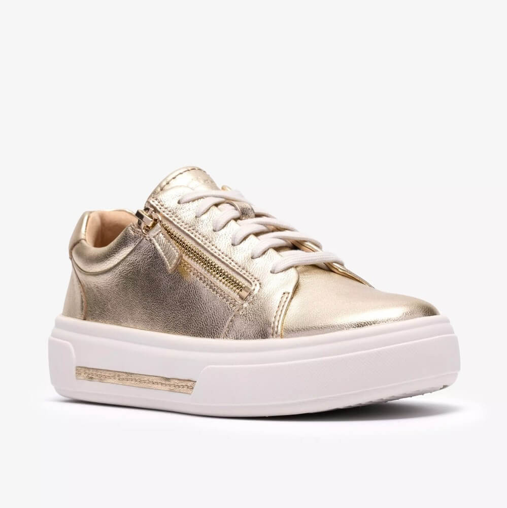 Clarks Gold sneaker with white sole on a white background
