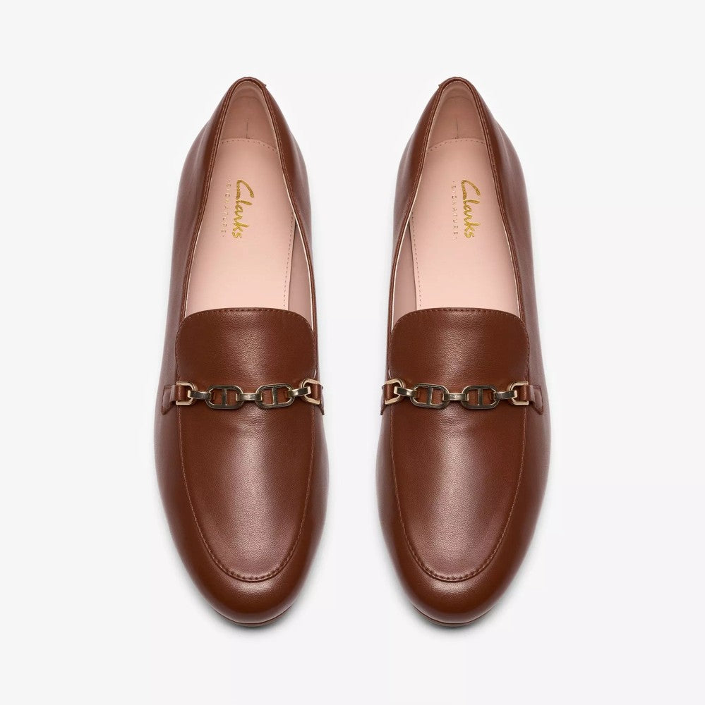 Pair of brown loafers with chain detail on a white background