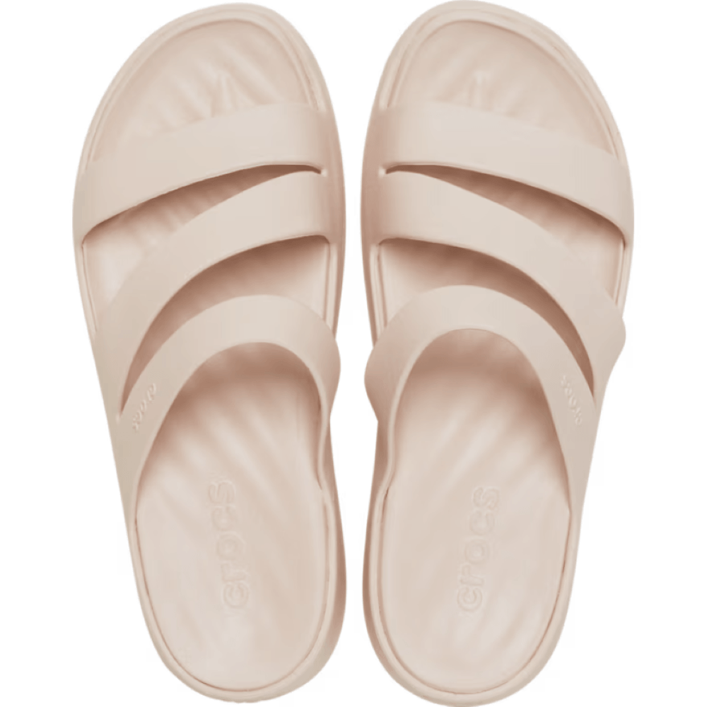 Pair of Crocs light pink slides on a white background