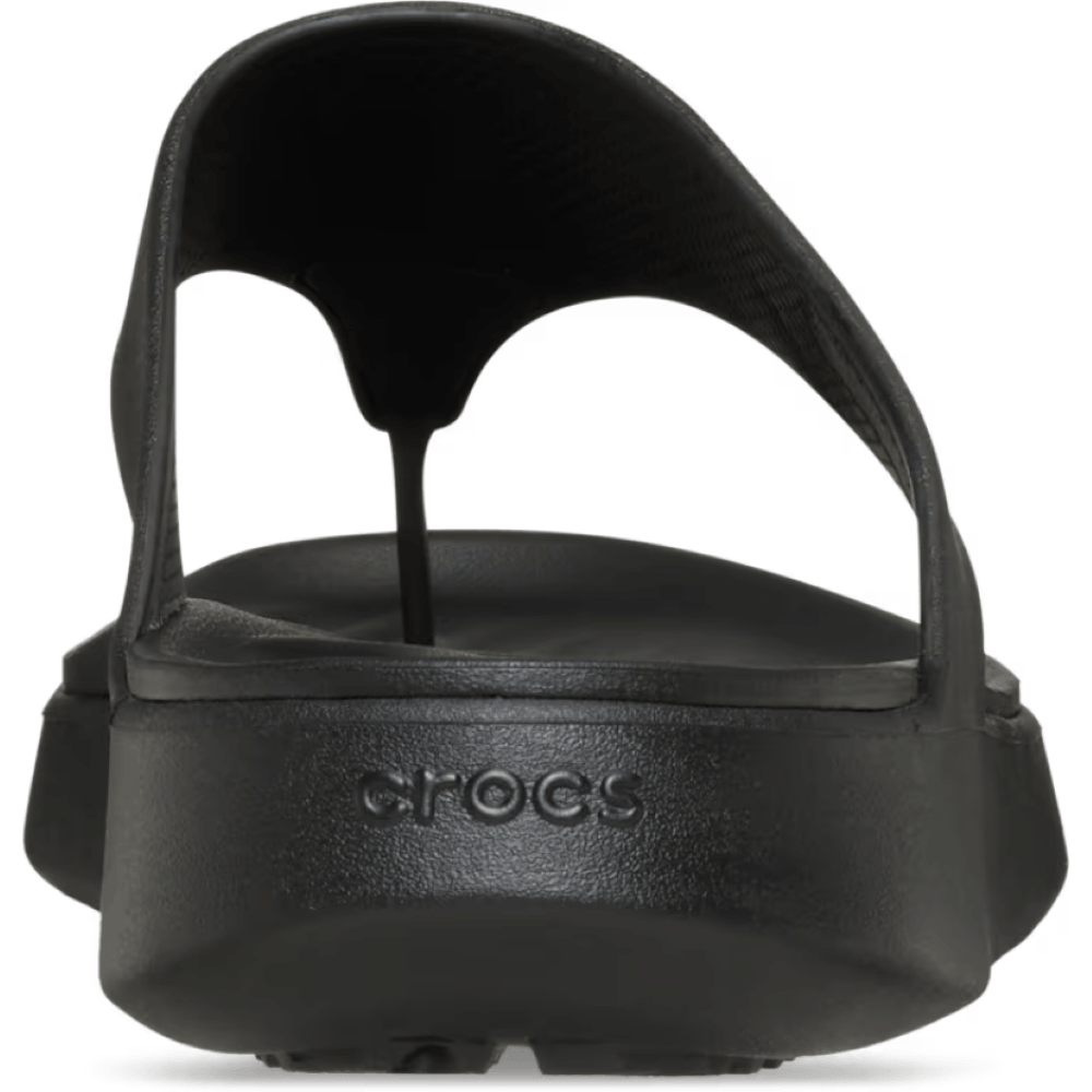 Black sandal with 'Crocs' branding on a white background