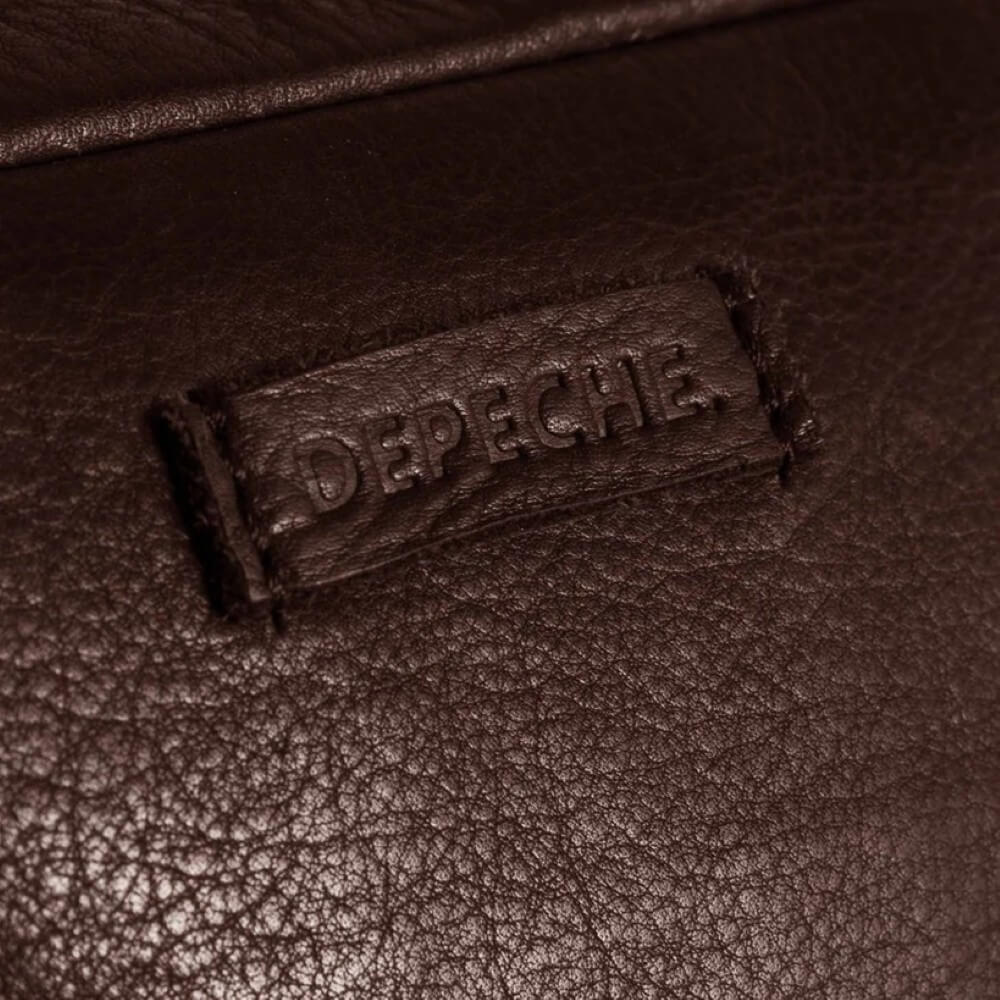 Close-up of a brown leather surface with 'Depeche' branding.