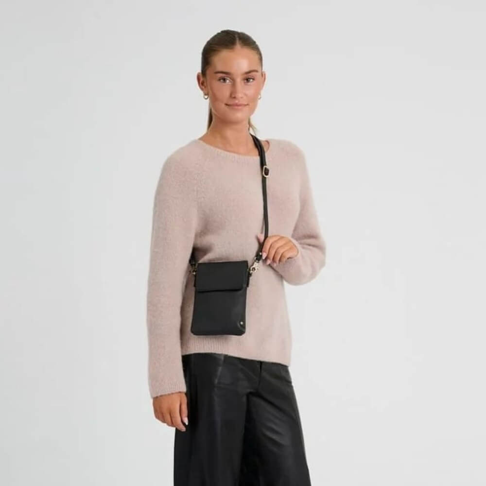 Person wearing a Depeche Black Leather Crossbody bag