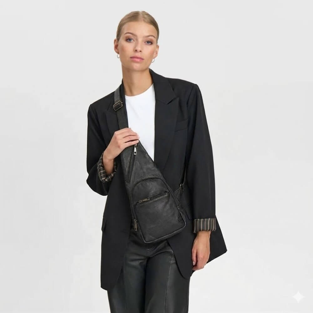 Person wearing a Black Leather Shoulder Bag With silver zips Depeche