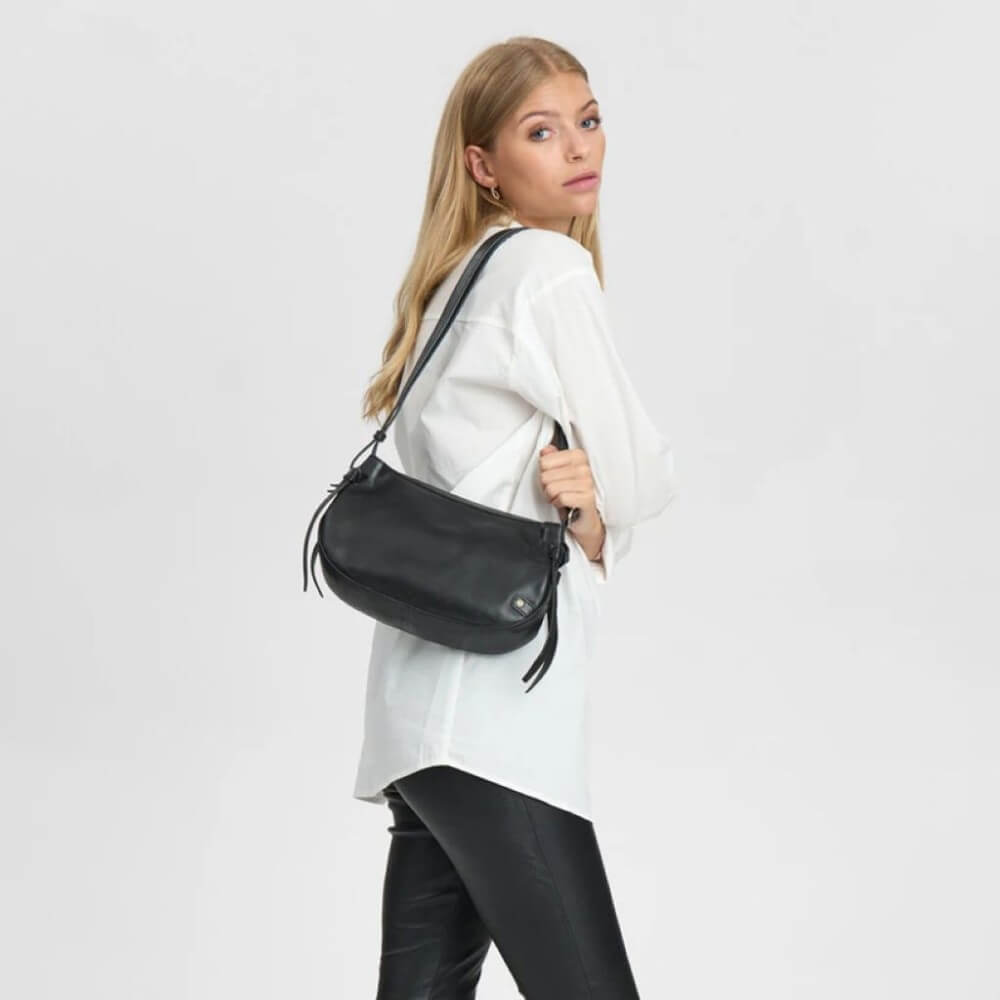 Person wearing a Black Leather Depeche Shoulder Bag