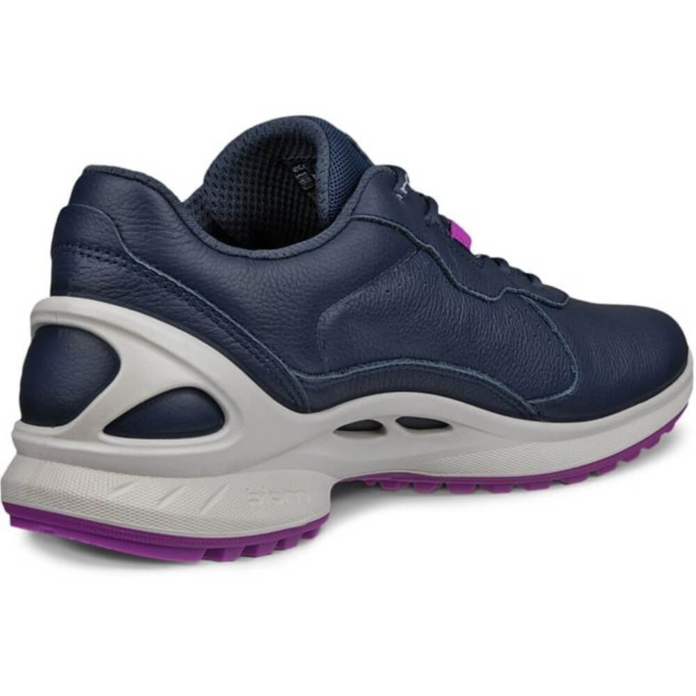 Navy blue athletic shoe with white sole and purple accents on a white background