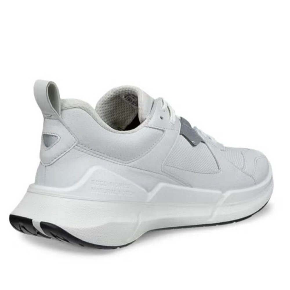 White sneaker with black sole on a white background
