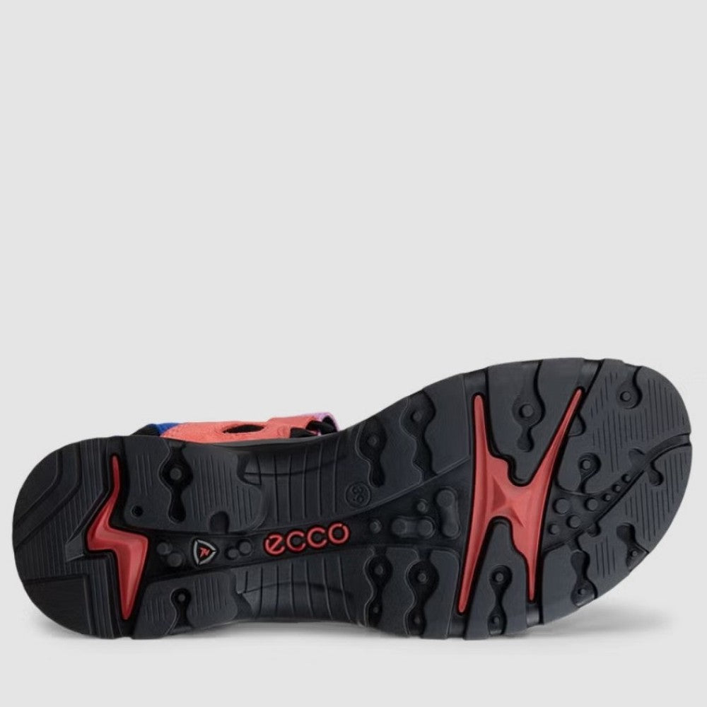 Close-up of a shoe sole with red and black design on a light gray background
