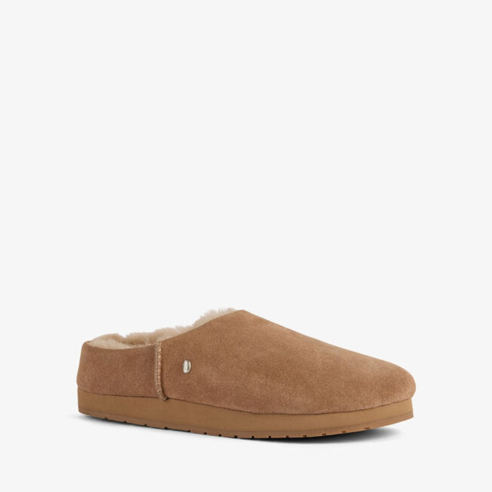 An EMU tan suede slip-on mule slipper with a soft cream wool lining and a tan rubber sole, shown from a side profile on a light gray background.