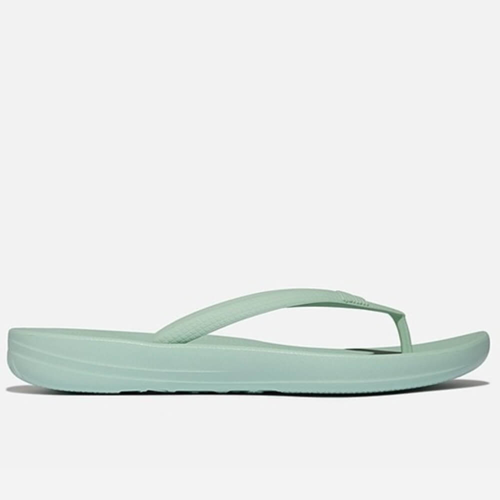 Mint green flip-flop sandal on a white background