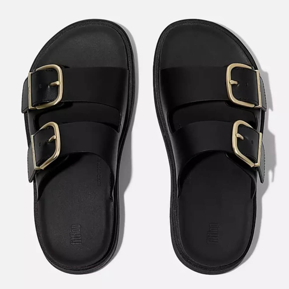 fitflop Black sandal with gold buckles on a white background