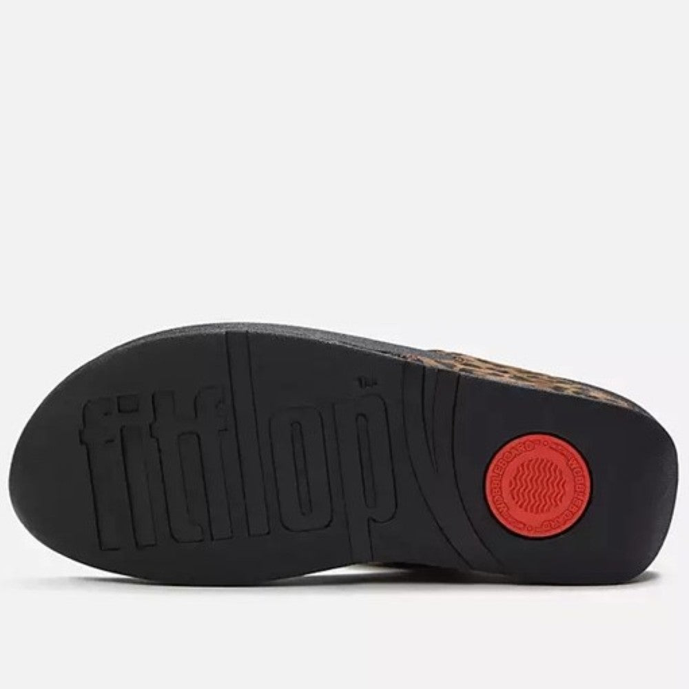 Black shoe sole with 'fitflop' branding and a red circular logo on a white background