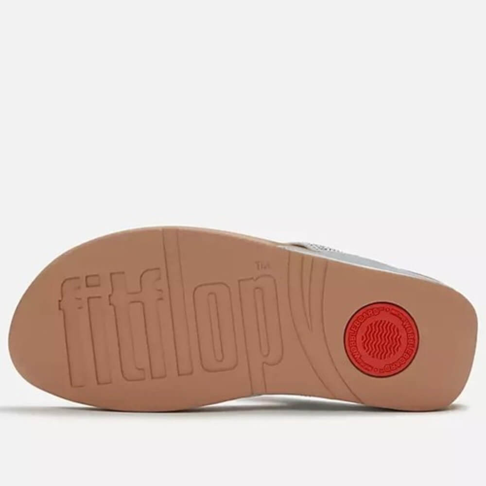 Close-up of a FitFlop sandal sole with brand logo on a white background