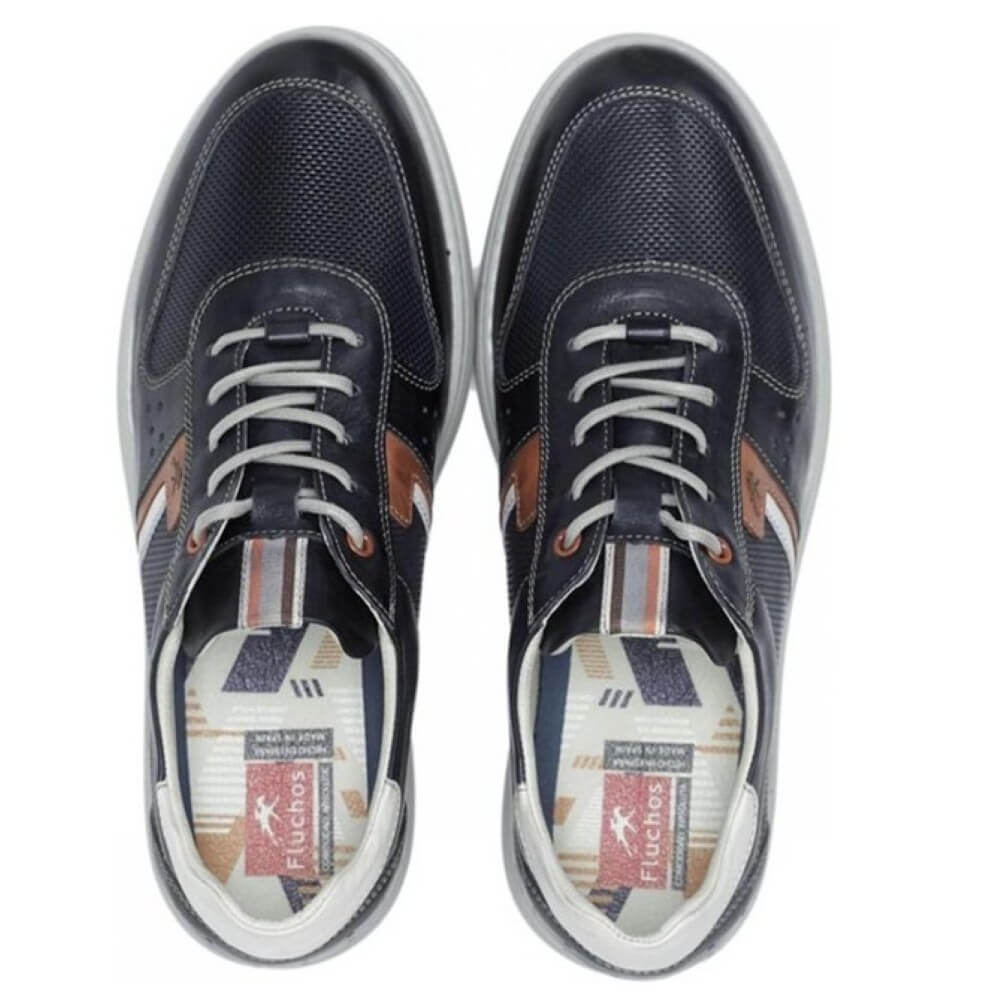 Pair of navy blue shoes with white laces on a white background