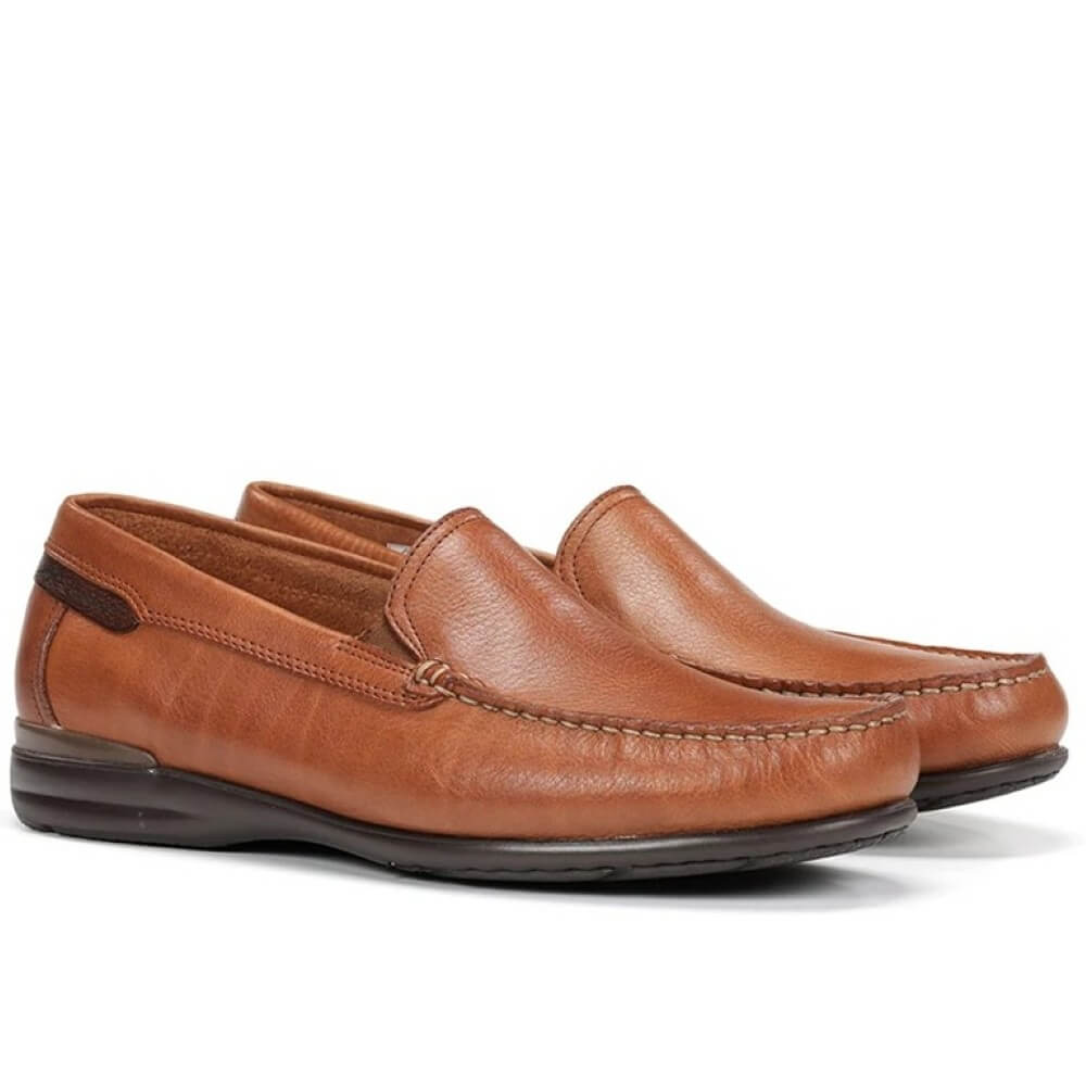Pair of Fluchos brown leather loafers on a white background