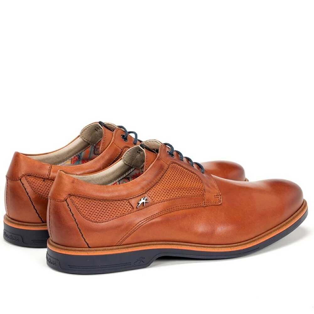 Pair of Fluchos brown leather shoes with black laces on a white background