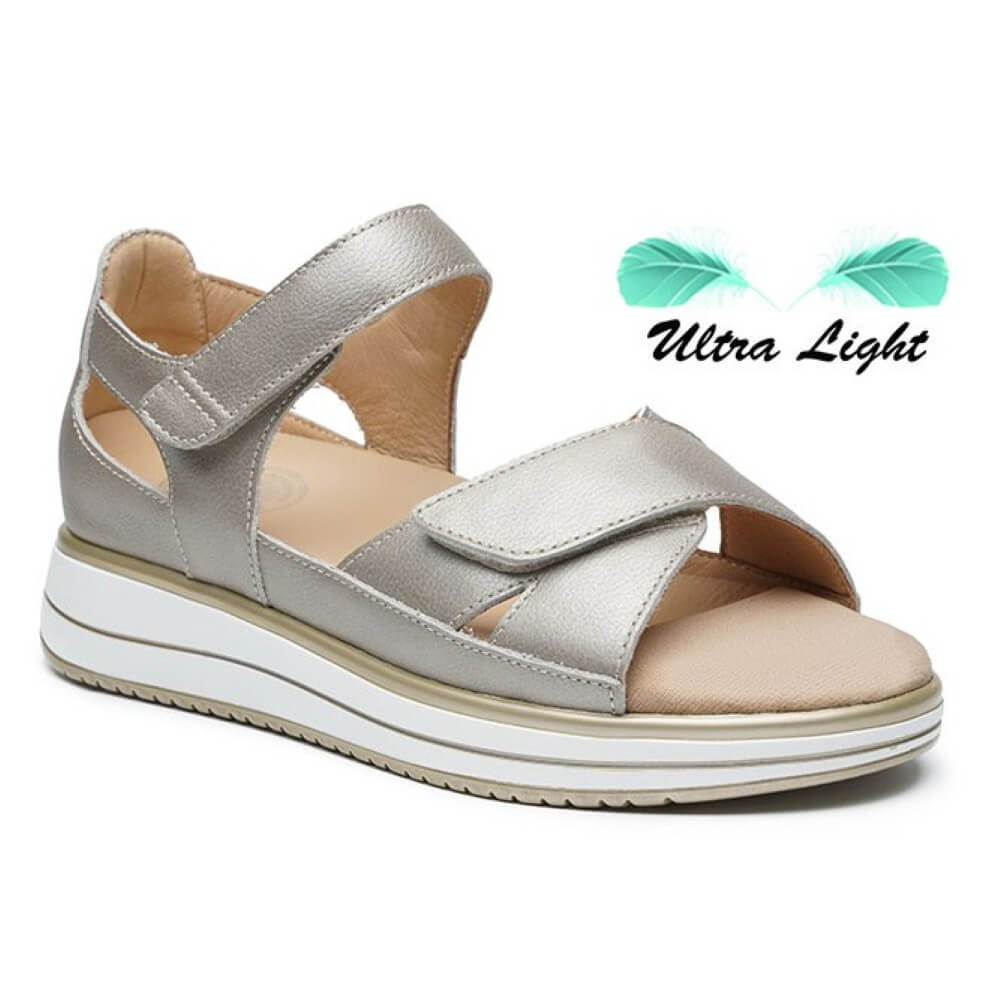 G Comfort Gold sandal with white sole on a light beige background, featuring 'Ultra Light' text.