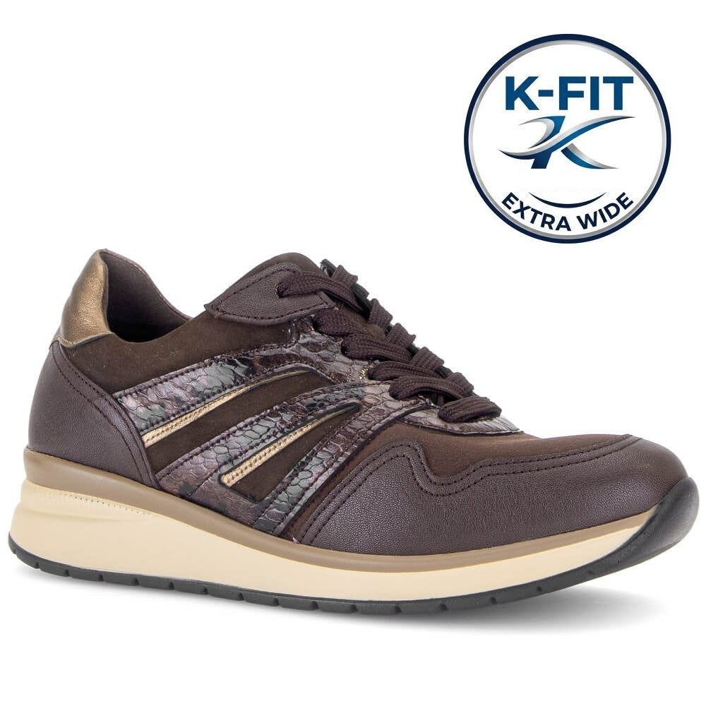A Gabor dark brown wide-width sneaker with textured snakeskin-patterned side stripes, a beige midsole, and a black outsole. A circular 'K-FIT EXTRA WIDE' logo badge is displayed in the upper right corner against a clean white background.