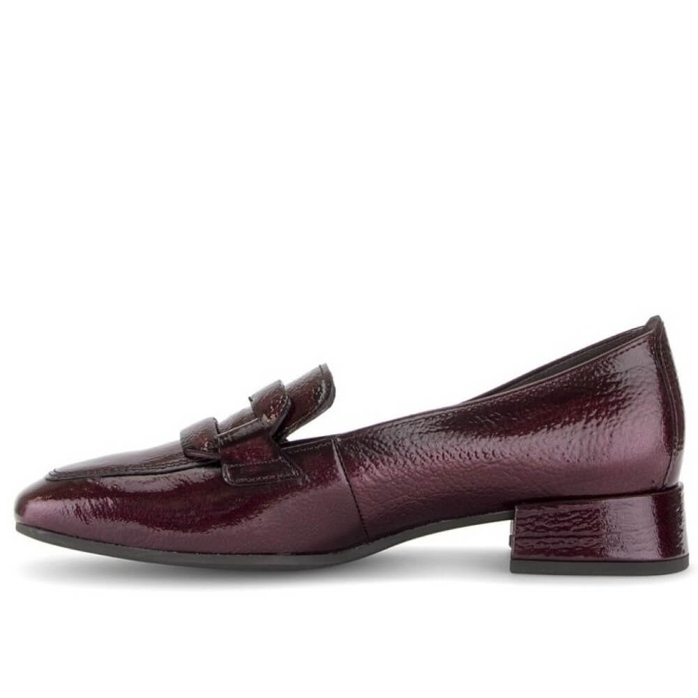 Gabor patent leather loafer in a deep burgundy colour, featuring a low block heel and a decorative strap detail across the vamp, shown against a plain white background.