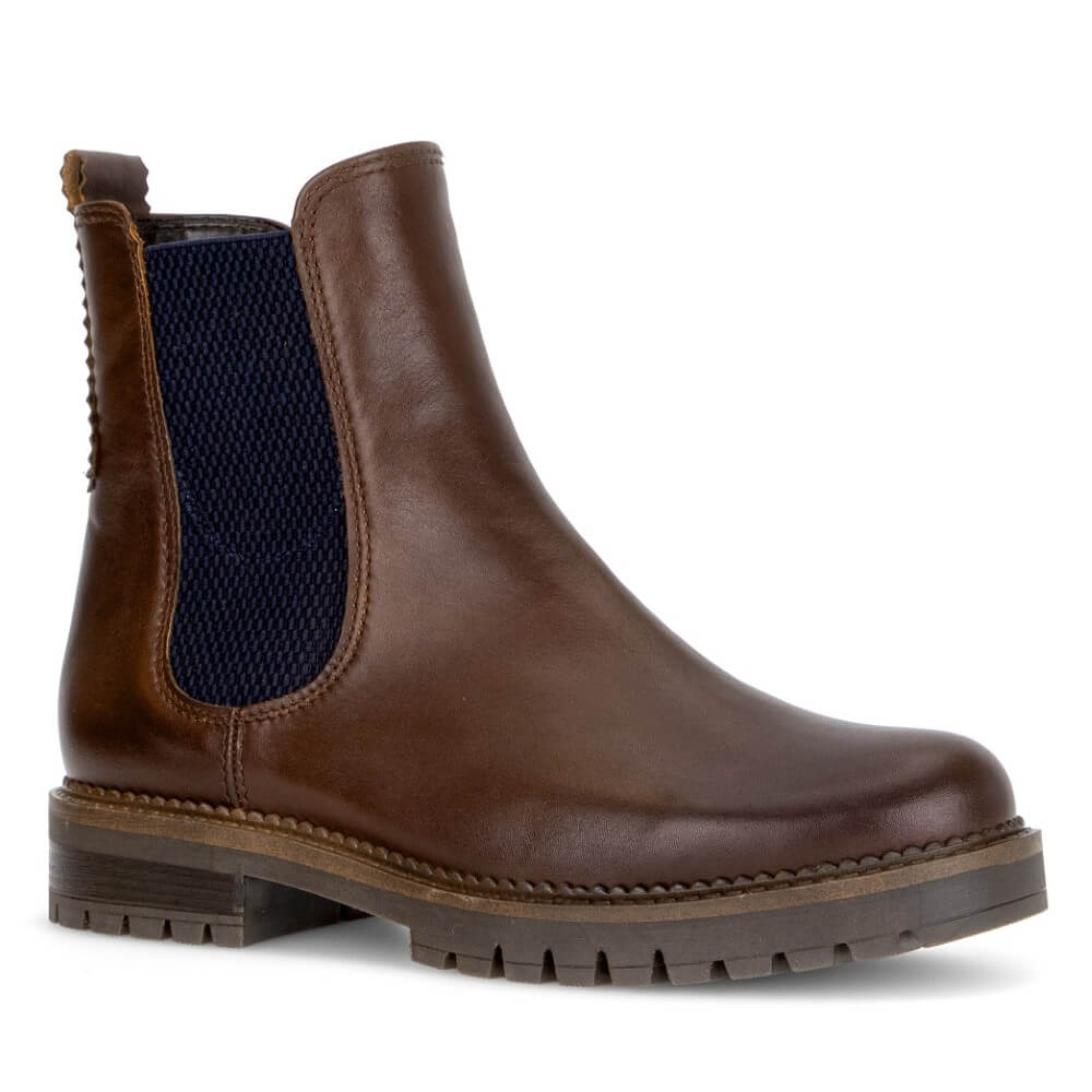 A Gabor brown leather Chelsea boot with dark navy blue elastic side panels and a chunky lug sole, shown from a three-quarters angle on a white background.