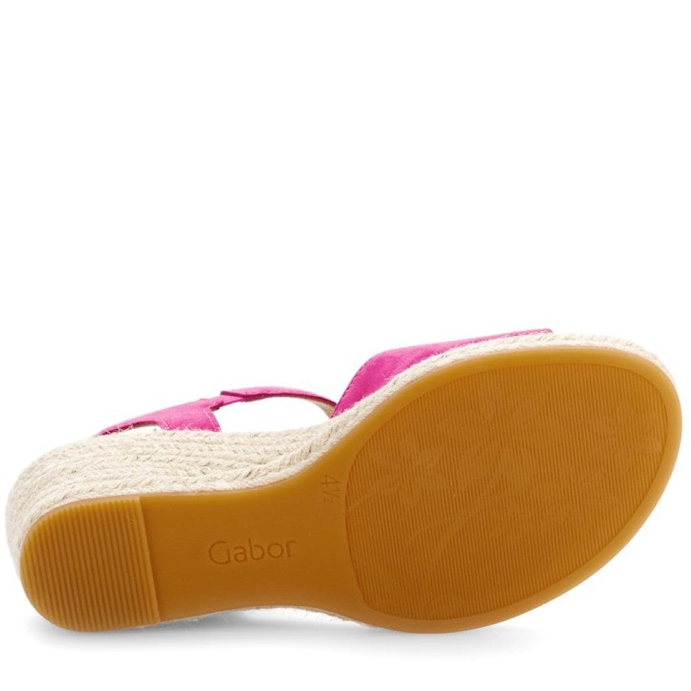 Pink sandal with a brown sole on a white background